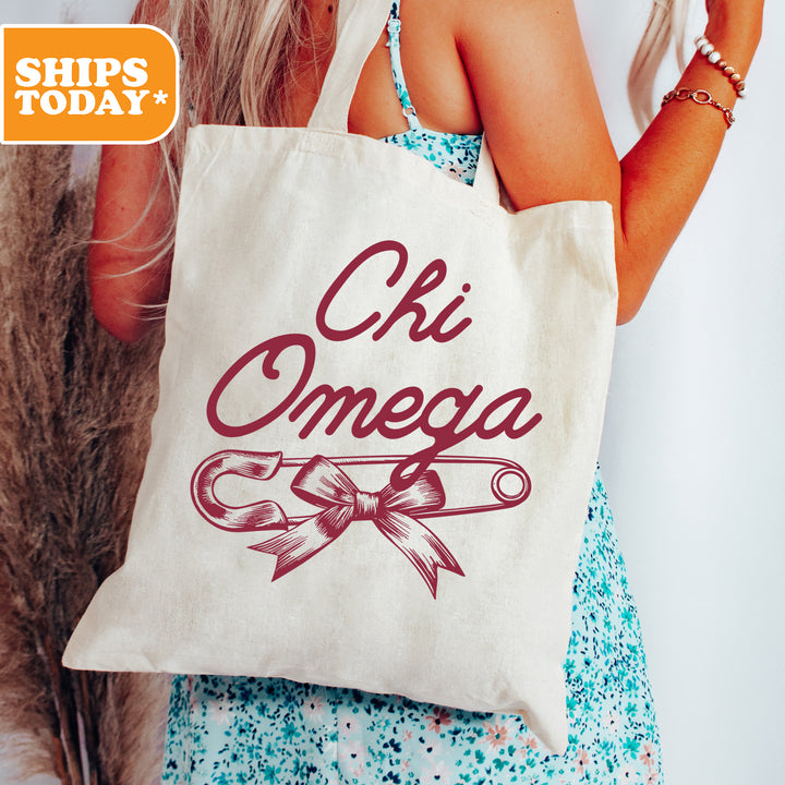 a woman holding a bag that says ohi omega