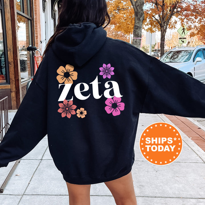 a woman in a black hoodie is walking down the street