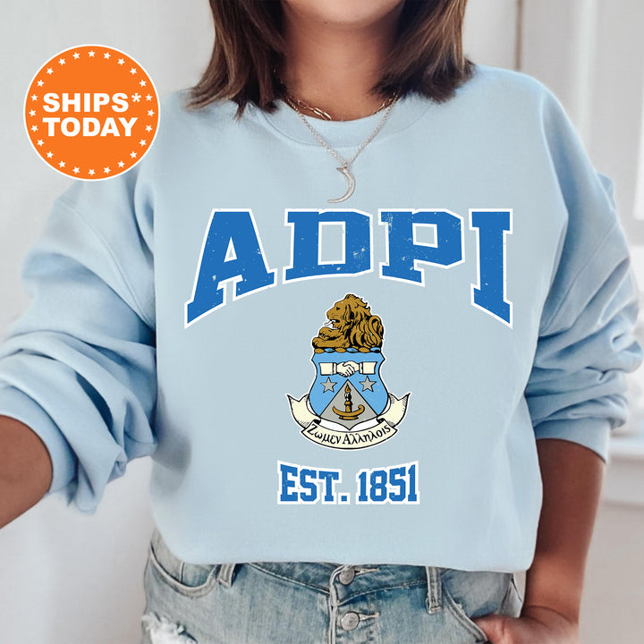 a woman wearing a blue sweatshirt with the words adpi on it