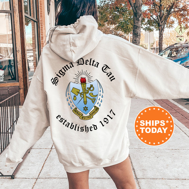 a woman walking down a sidewalk wearing a white hoodie