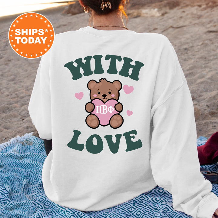 a woman sitting on a blanket with a teddy bear on it