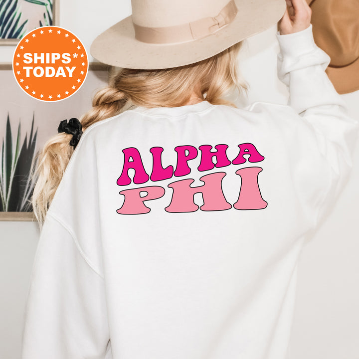 a woman wearing a white sweatshirt with pink letters on it