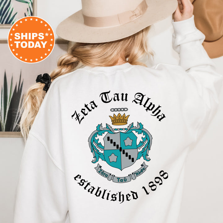 a woman wearing a white sweatshirt with a crown on it