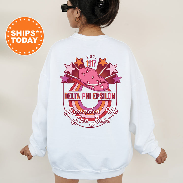 a woman wearing a white sweatshirt with a pink hat on it