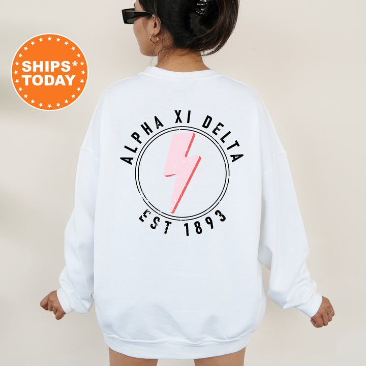 a woman wearing a white sweatshirt with a pink lightning bolt on it