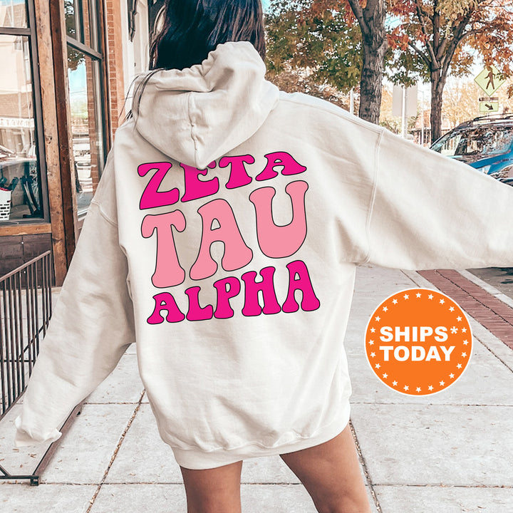 a woman walking down a sidewalk wearing a white hoodie