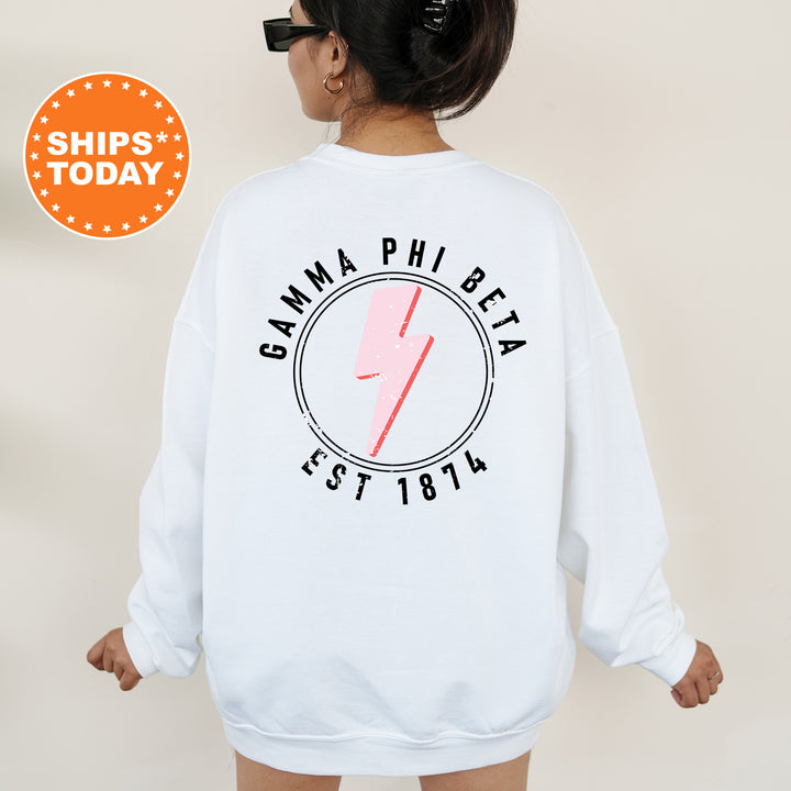 a woman wearing a white sweatshirt with a pink lightning bolt on it