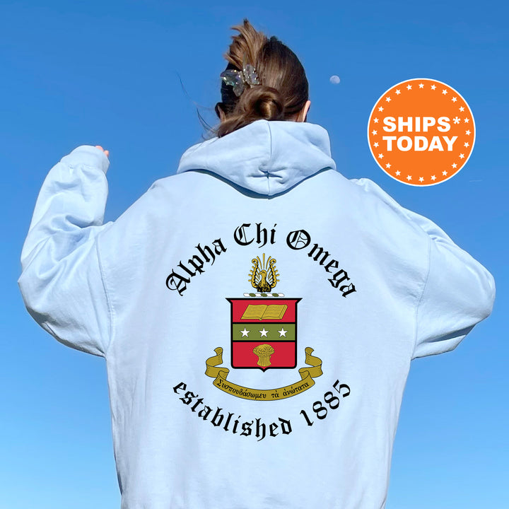 a woman wearing a white hoodie with an emblem on it