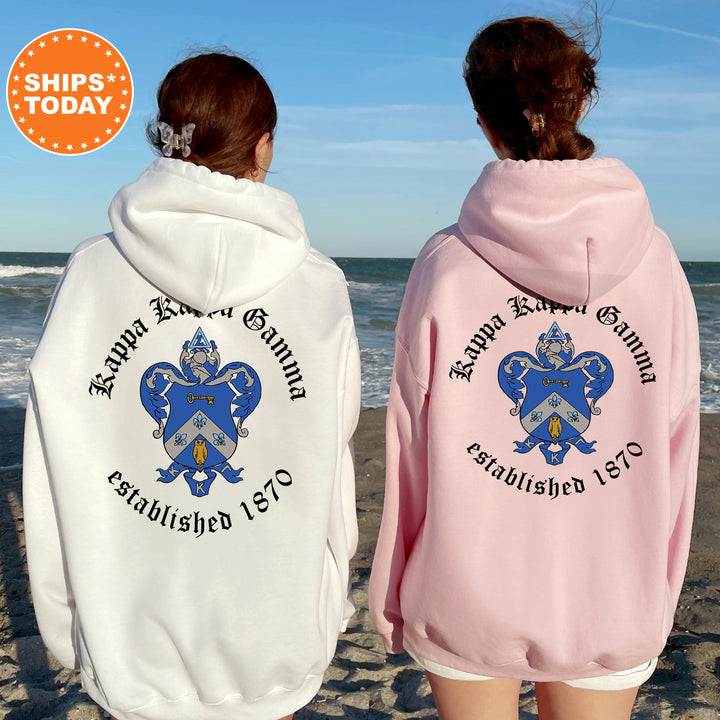 two women wearing matching sweatshirts on the beach