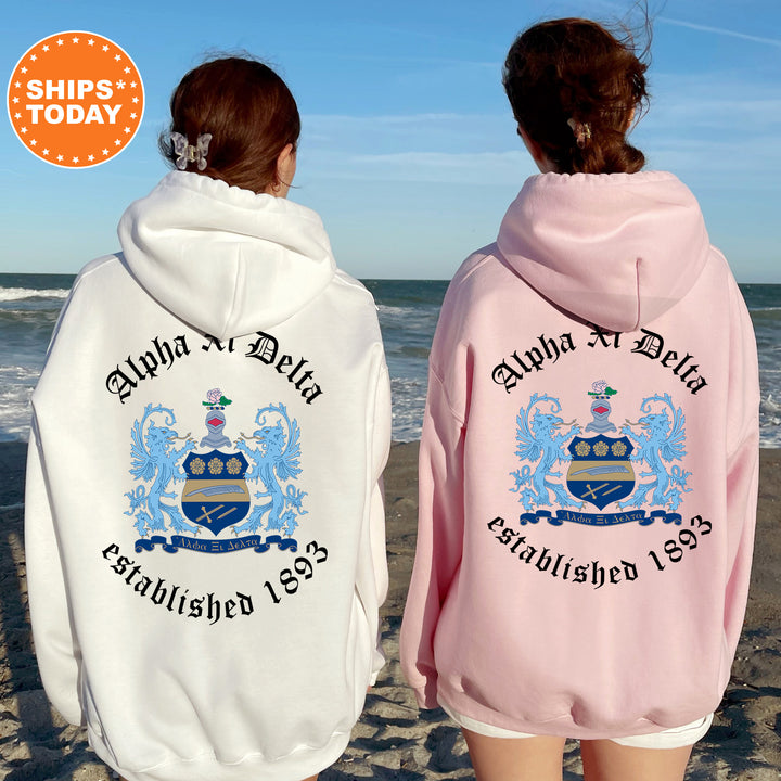 two women wearing matching sweatshirts on the beach