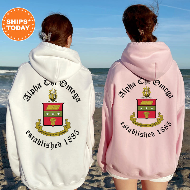 two women wearing matching sweatshirts on the beach