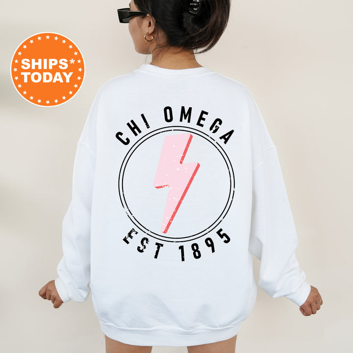 a woman wearing a white sweatshirt with a pink lightning bolt on it