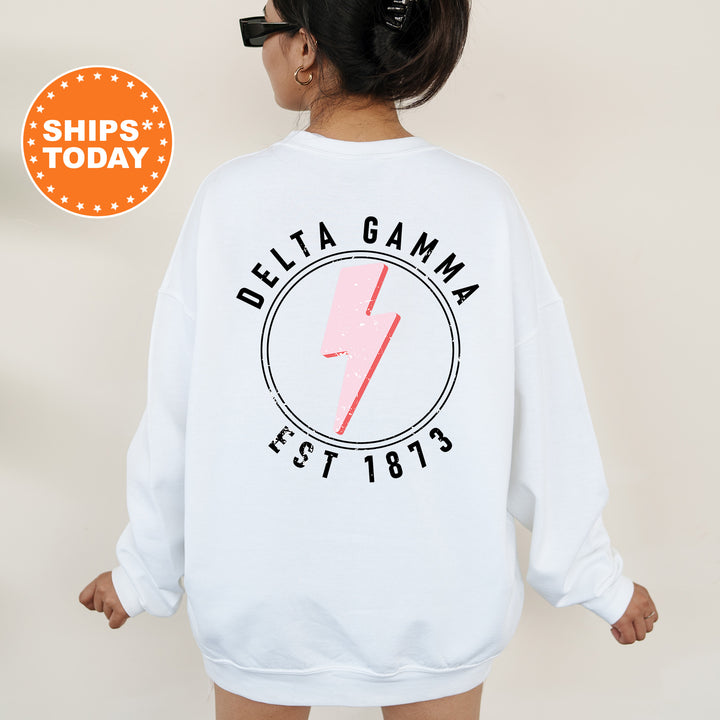 a woman wearing a white sweatshirt with a pink lightning bolt on it