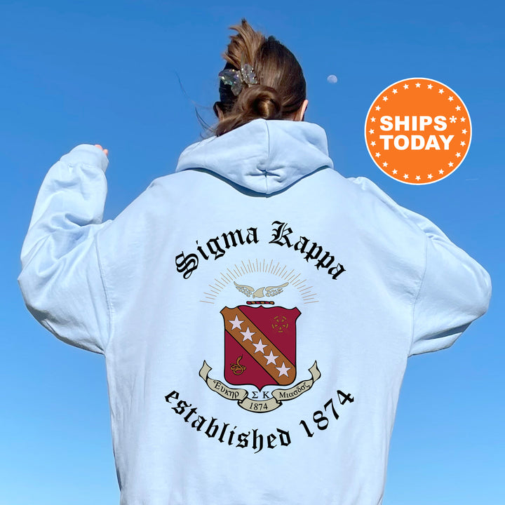 a woman wearing a white hoodie with a red and gold crest on it