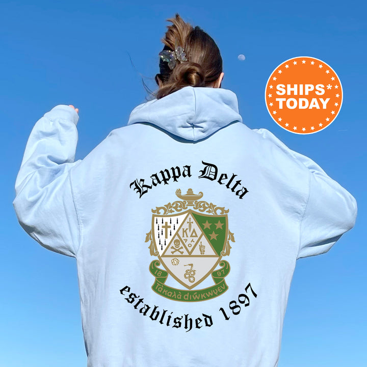 a woman wearing a white hoodie with a crest on it