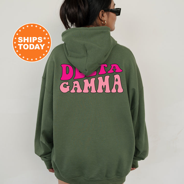 a woman wearing a green hoodie with pink letters on it