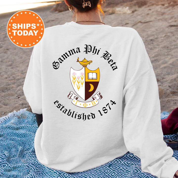 a woman sitting on a blanket on the beach