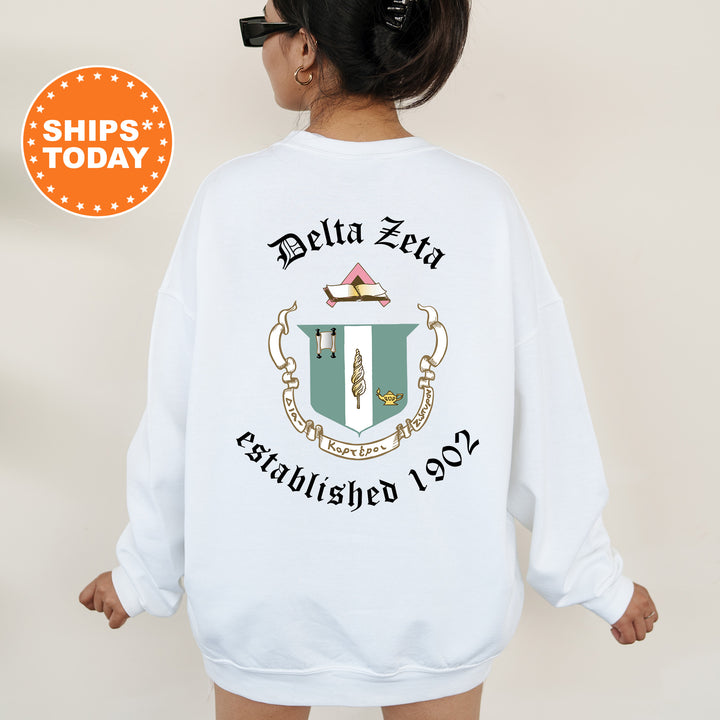a woman wearing a white sweatshirt with a crest on it