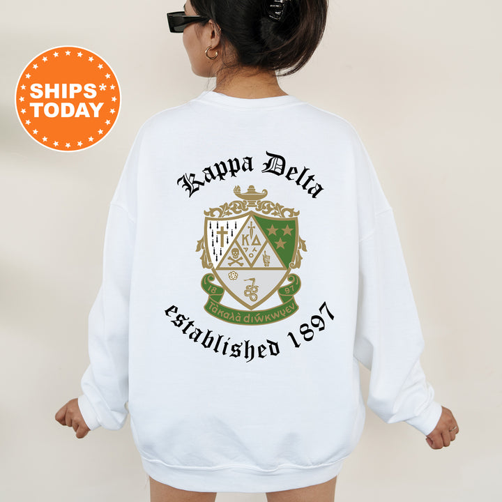 a woman wearing a white sweatshirt with a green and gold crest on it