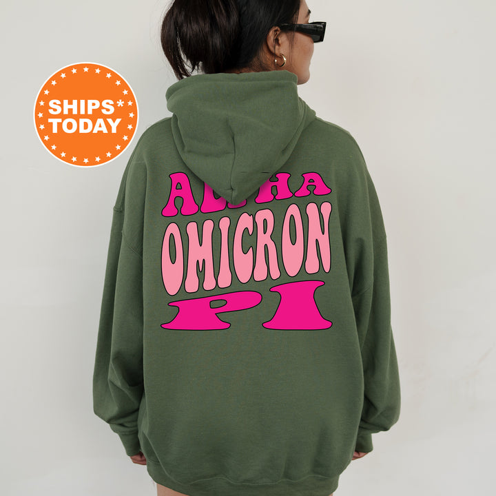 a woman wearing a green sweatshirt with pink letters on it
