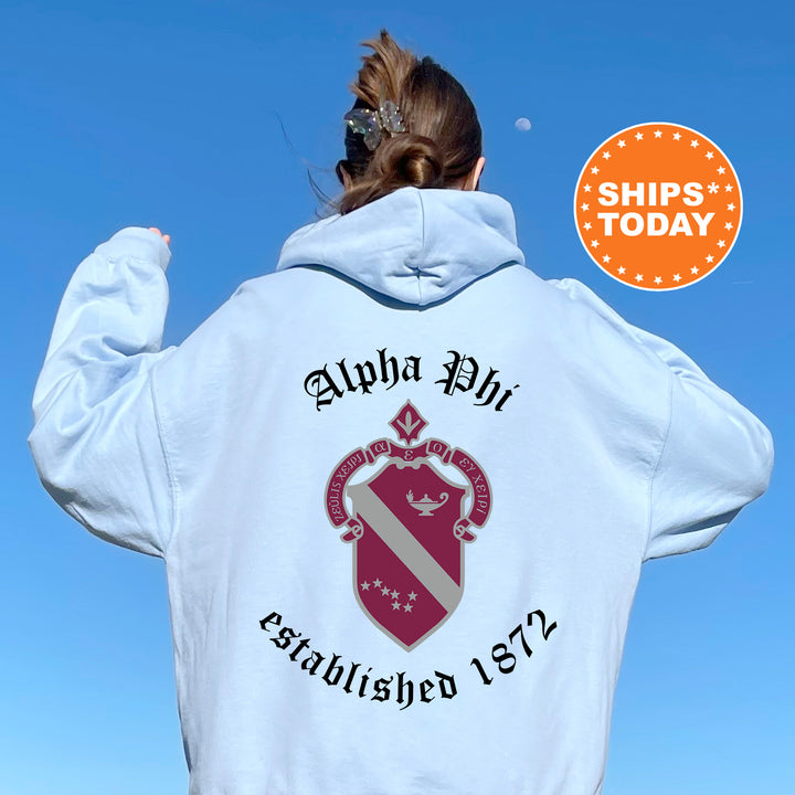 a woman wearing a white hoodie with a red and white crest on it