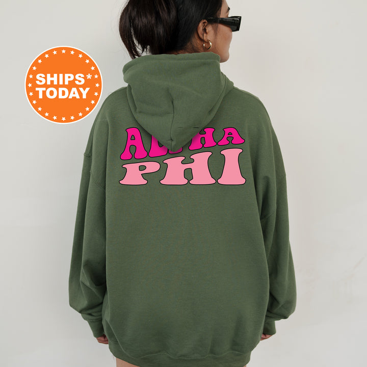 a woman wearing a green hoodie with pink letters on it