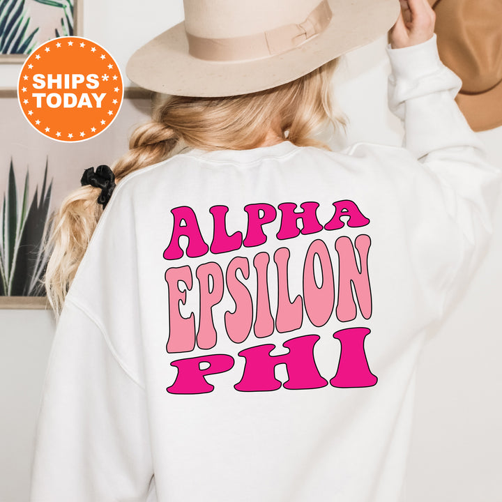 a woman wearing a white sweatshirt with pink letters on it