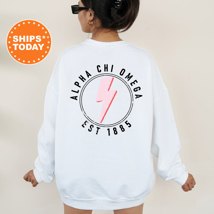 a woman wearing a white sweatshirt with a pink lightning bolt on it