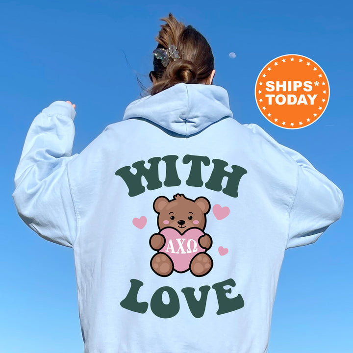 a woman wearing a white hoodie with a teddy bear on it