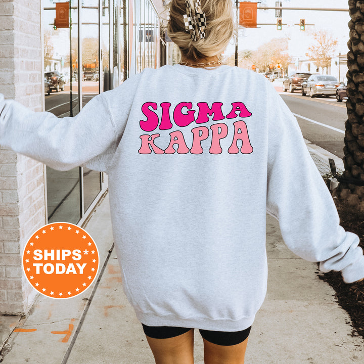 a woman walking down a sidewalk wearing a sweatshirt