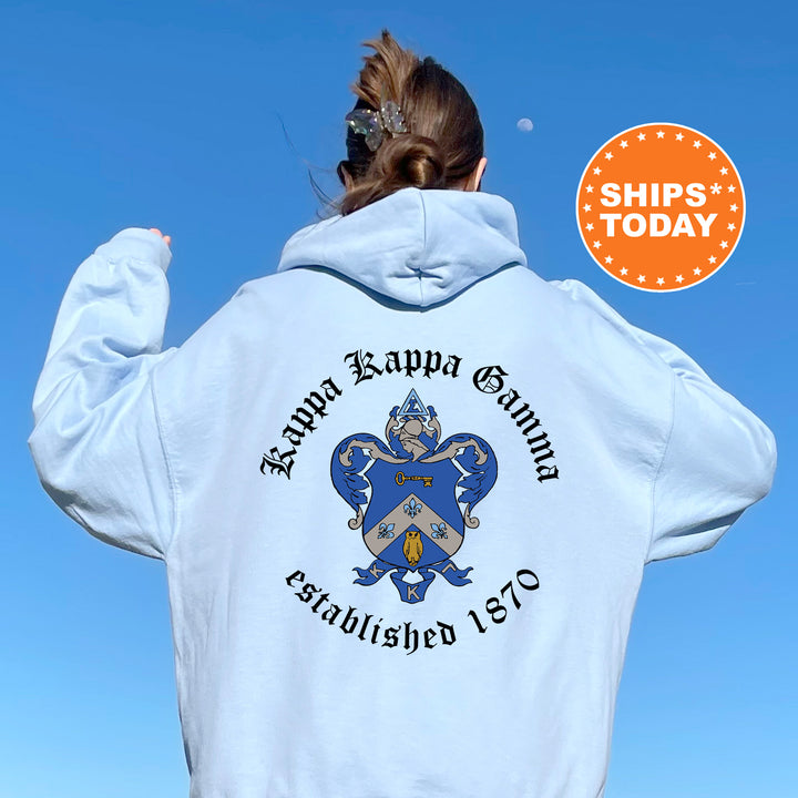 a woman wearing a white hoodie with a blue crest on it
