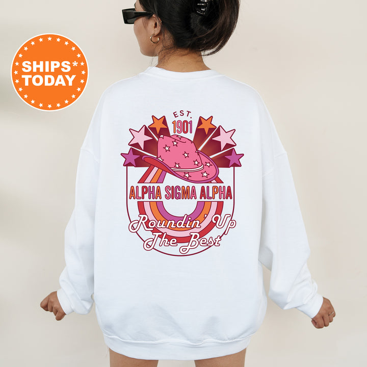a woman wearing a white sweatshirt with a pink hat on it