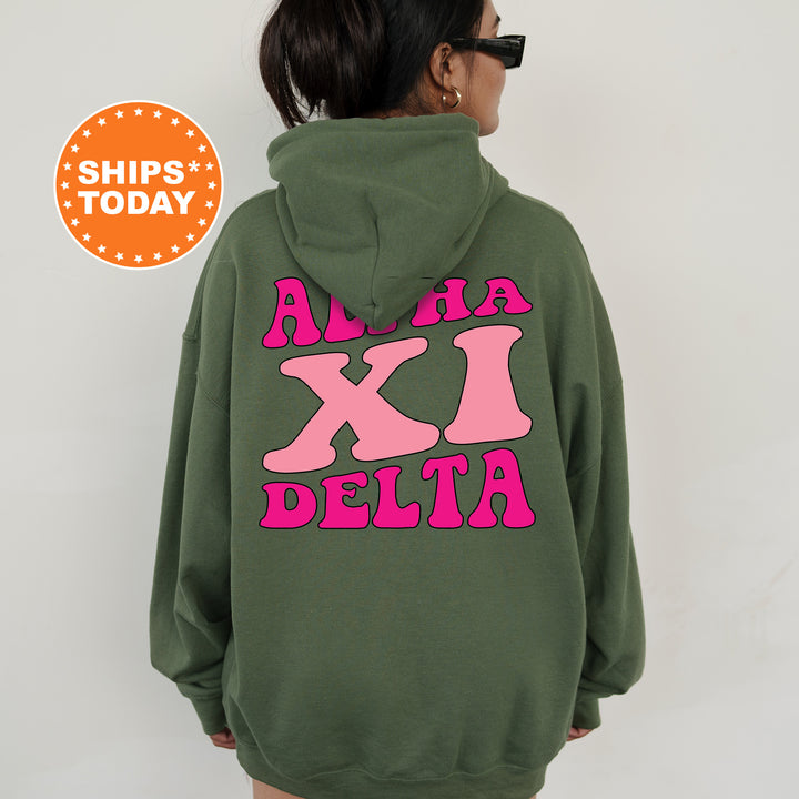 a woman wearing a green hoodie with pink letters