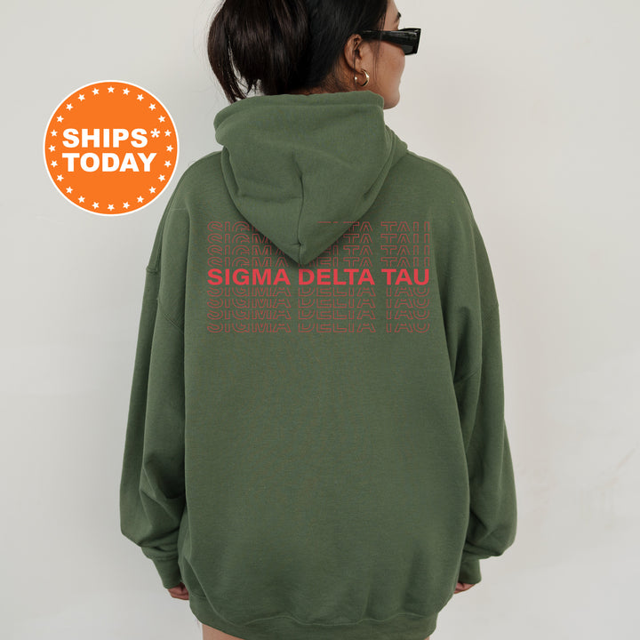 a woman wearing a green hoodie with the words stigma delta tau printed on it