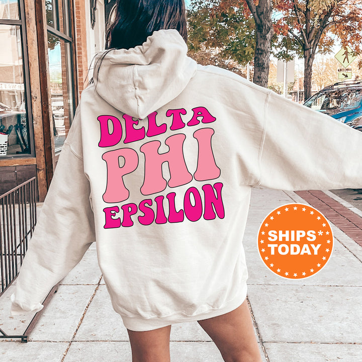 a woman walking down a sidewalk wearing a white hoodie