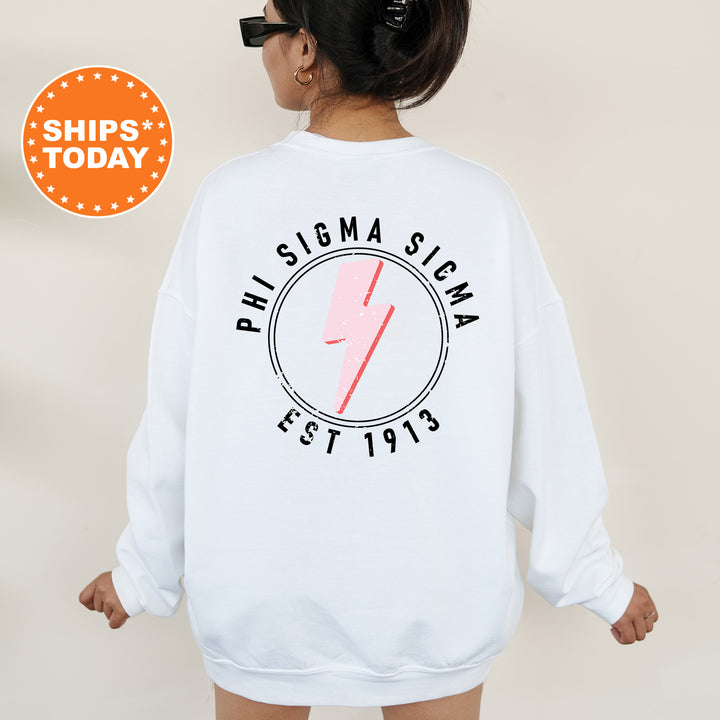 a woman wearing a white sweatshirt with a pink lightning bolt on it