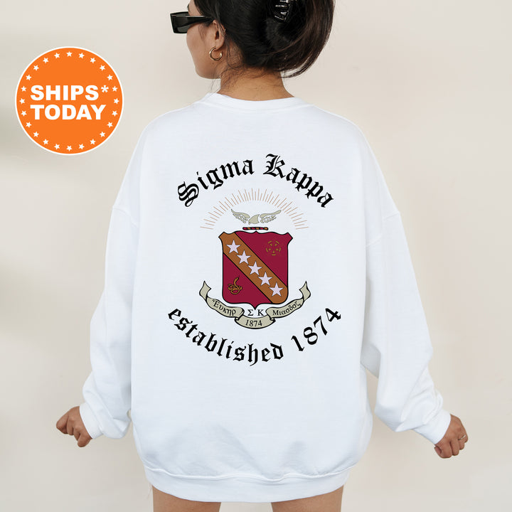 a woman wearing a white sweatshirt with a red and white crest on it
