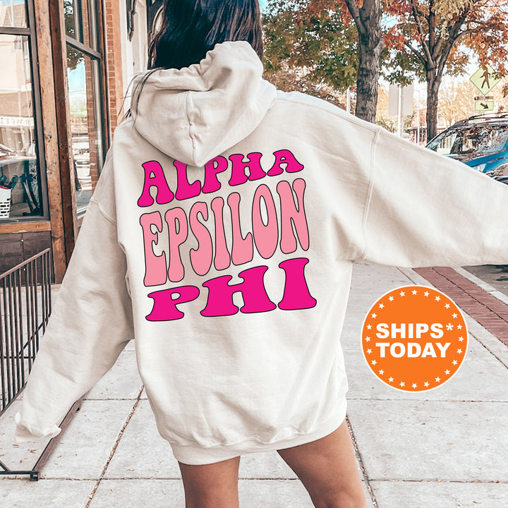 a woman walking down a sidewalk wearing a white hoodie
