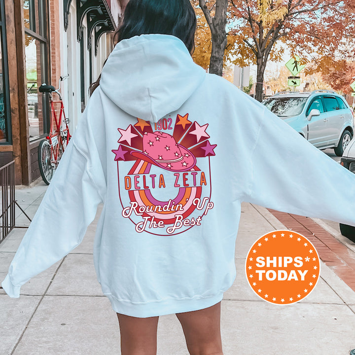 a woman in a white hoodie is walking down the street
