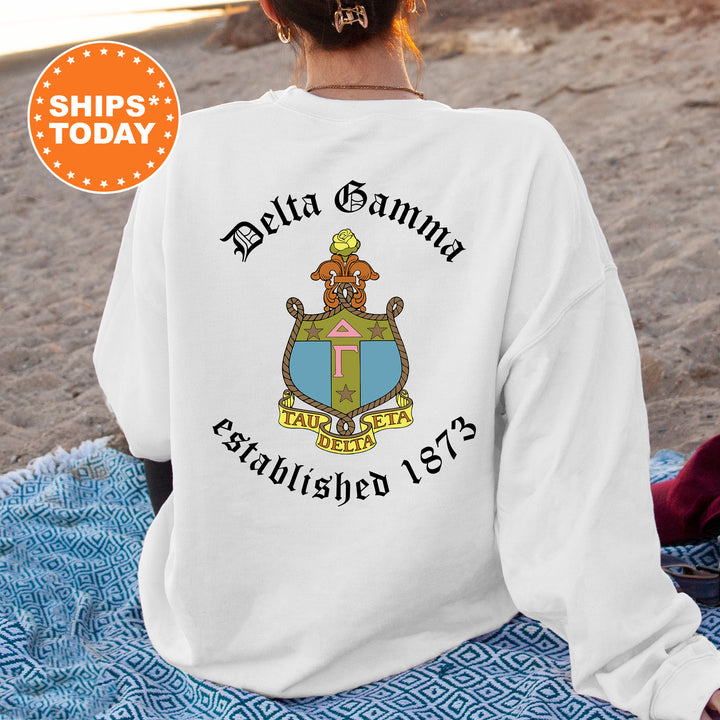 a woman is sitting on a blanket on the beach