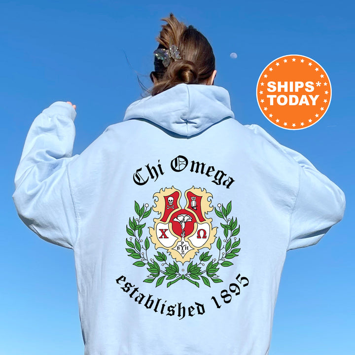 a woman wearing a white hoodie with a crest on it