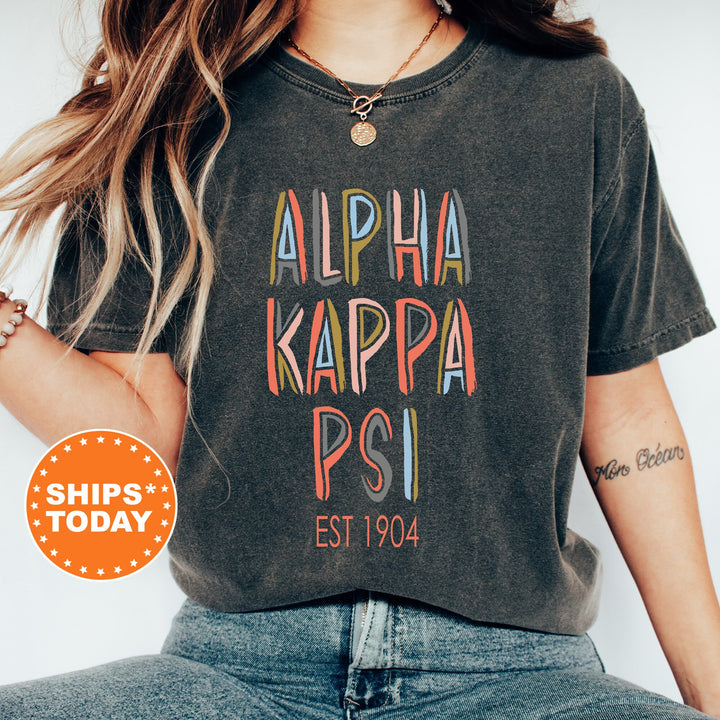 Alpha Kappa Psi Pastel Stencil Coed T-Shirt | AKPsi Comfort Colors Shirt | Fraternity Apparel | Bid Day Gift | Custom Greek Apparel _ 8831g