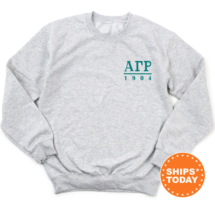 a grey sweatshirt with a green logo on it
