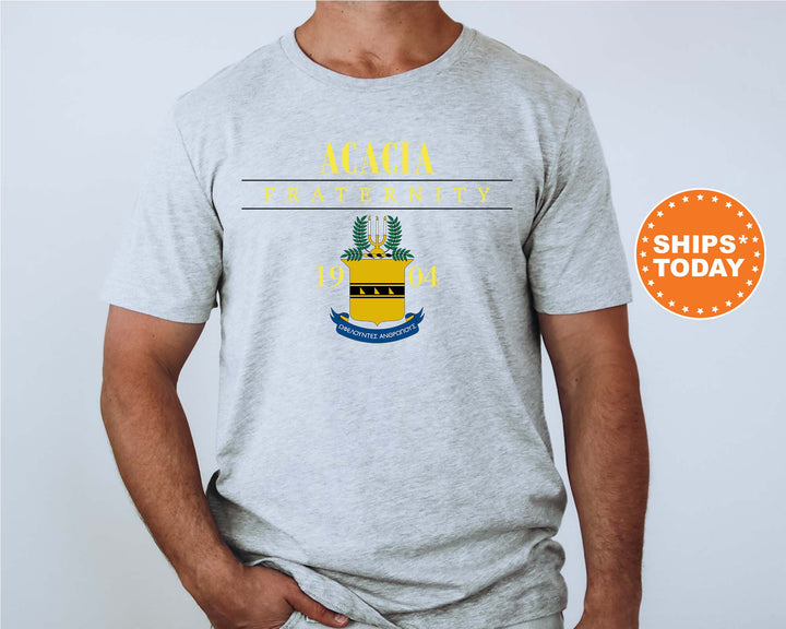 a man wearing a grey shirt with a yellow and blue crest on it