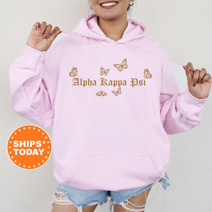 a woman wearing a pink hoodie with butterflies on it