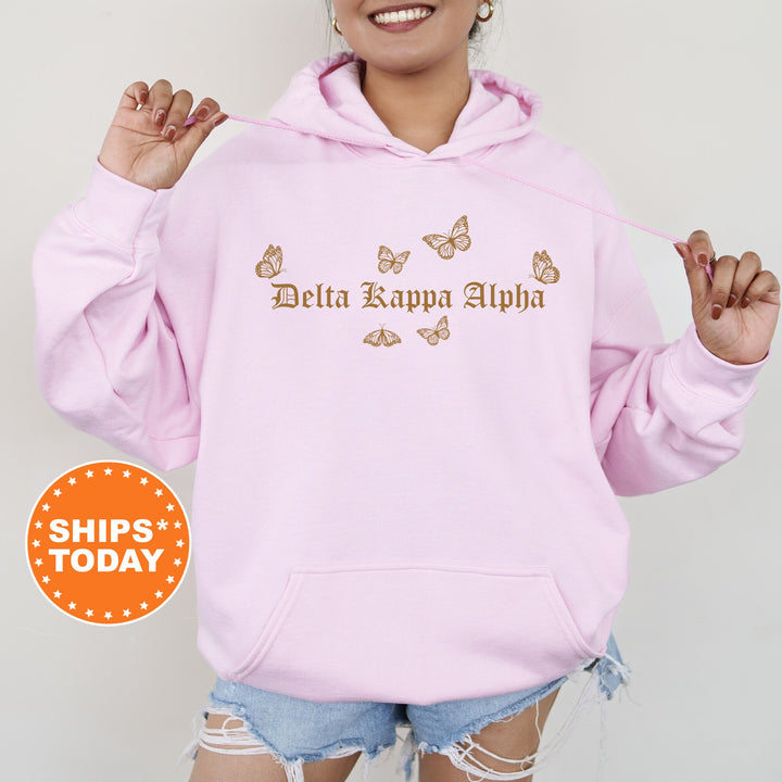 a woman wearing a pink hoodie with butterflies on it