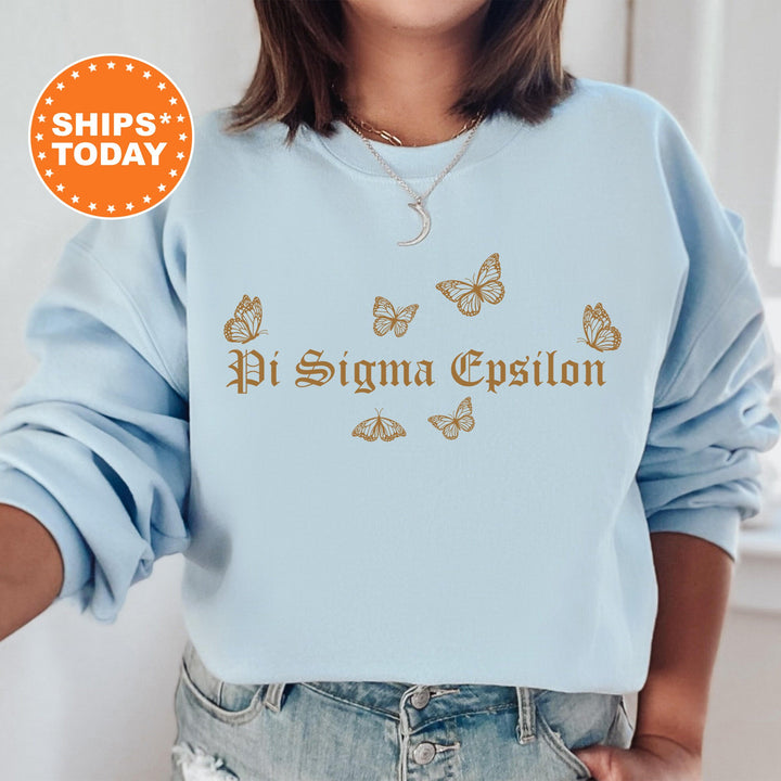 a woman wearing a light blue sweatshirt with butterflies on it