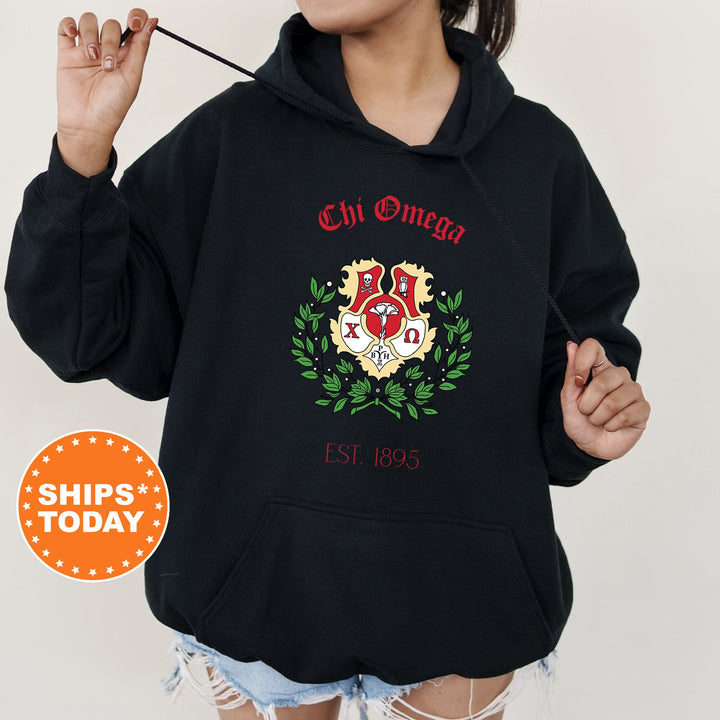 a woman wearing a black hoodie with a crest on it