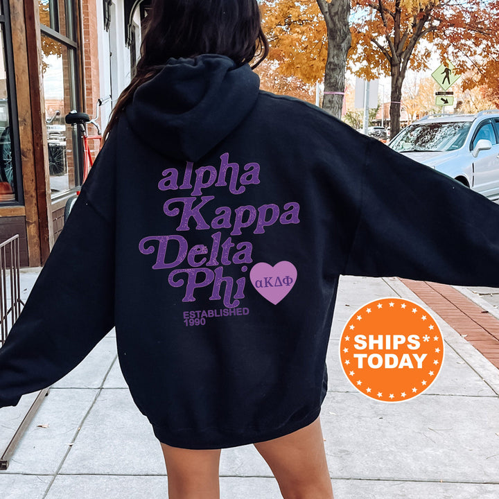 a woman in a black hoodie is walking down the street