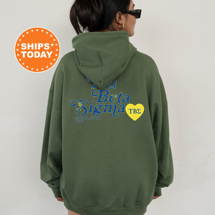 a woman wearing a green hoodie with a yellow heart on it